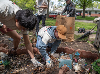 Delta Phi Fraternity’s Ben Huffer and Quinny Brumbaugh, clear away leaves and debris from a homeowner’s decorated garden during the Big Event. May 4, 2024. Photo by Kirk Rangel for University Communication.